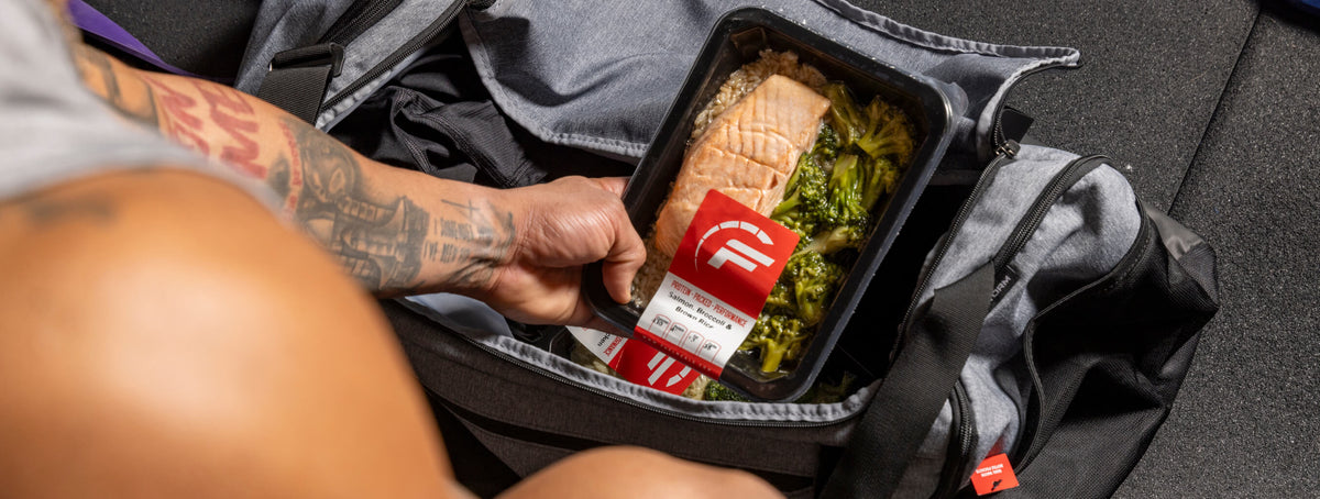 Fuel Meals container with salmon and broccoli into a gym bag, highlighting convenient and nutritious meal options.